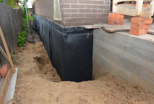 SJ Waterproofing Pros technician performing targeted Exterior Waterproofing assessment in Brentwood, NY